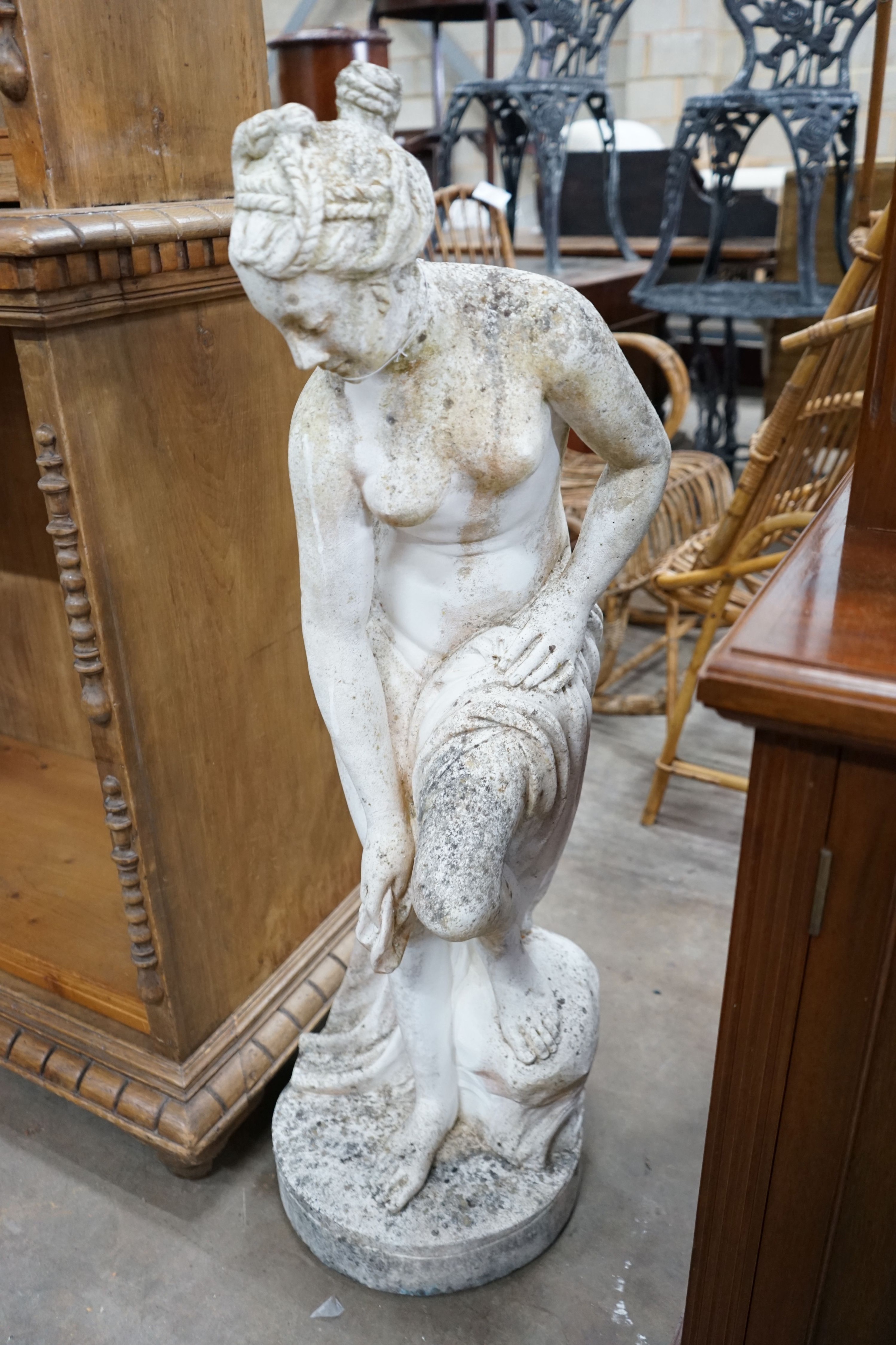 A reconstituted stone garden ornament of a female bather, height 102cm